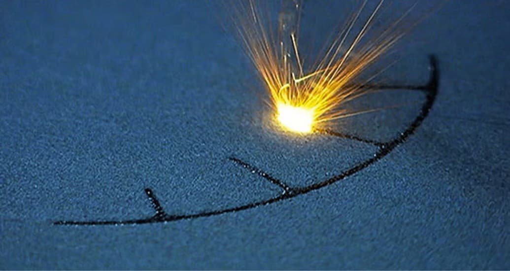 Technician performing finishing work on metal parts in an industrial workshop